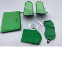 The green hotel amenity set includes a storage bag, slippers, eye mask, toothbrush, and toothpaste brand 5 Star Cosmetics.