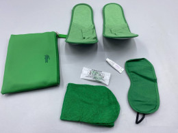 The green hotel amenity set includes a storage bag, slippers, eye mask, toothbrush, and toothpaste brand 5 Star Cosmetics.