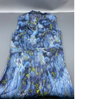 A blue dress with a nature-inspired pattern featuring flowers and trees.