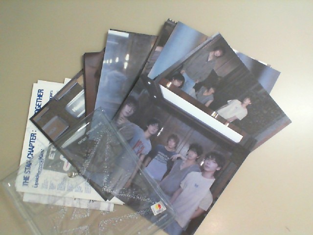A set of photos of a Korean music group, plus a folder for storage. A set of photos of a Korean music group, plus a folder for storage.