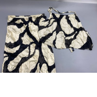  matching two-piece set featuring a top and a skirt in a black and white abstract pattern.