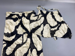  matching two-piece set featuring a top and a skirt in a black and white abstract pattern.