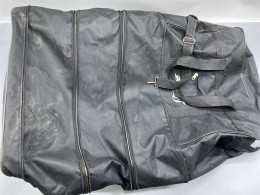 A large black suitcase or a convertible garment bag. A large black suitcase or a convertible garment bag.