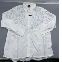  white blouse from Shoeby, featuring prominent geometric laser-cut designs on the shoulders and chest.