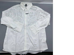  white blouse from Shoeby, featuring prominent geometric laser-cut designs on the shoulders and chest.