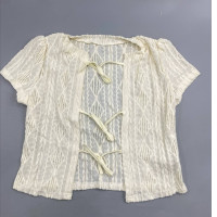 Short-sleeved blouse with front tie closure and openwork lace fabric. SHEIN LUNE collection.