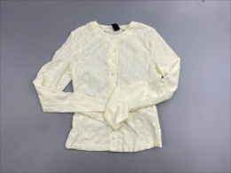  white eyelet or lace-textured cardigan sweater featuring a crew neck and front button closure. 