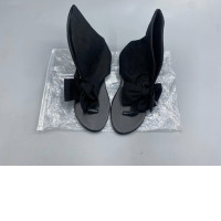 Black suede slingback sandals with bow embellishment for women.