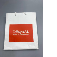 white paper shopping bag branded with the Dermal Korea logo.