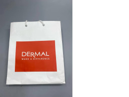 white paper shopping bag branded with the Dermal Korea logo.