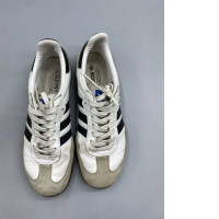 Adidas Samba OG shoes in a classic white and black colorway. 