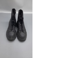 Black, lace-up, military-style boots with a thick, high heel, a style from the Zara brand.