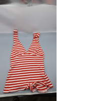 Deep V-neck knitted jumpsuit in red and white stripes.