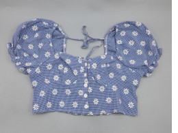 A cropped top with puffed sleeves, a small floral print, a front tie closure, and ruffle details from the brand SHEIN Essnce.