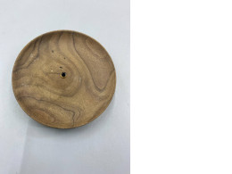 A wooden incense holder or stick holder.