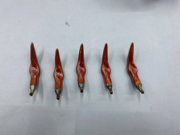 set of 5 Chopstick rest in the shape of a chili pepper.