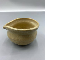 A pitcher with a narrow spout for pouring water.