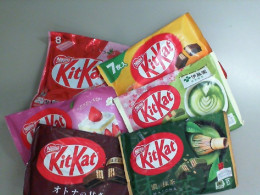 A set of 6 packages of different Kit Kat flavors.