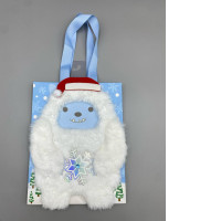  decorative holiday gift bag featuring a plush Abominable Snowman or Yeti character wearing a Santa hat. 