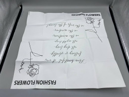 White gift wrapping paper decorated with a floral pattern.