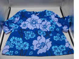women's blue floral printed top featuring short sleeves and a round neckline. 