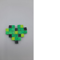 A heart-shaped craft made from small, painted wooden blocks.