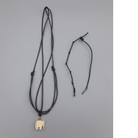 Set of 2 A black braided cord necklace with a plastic elephant pendant.