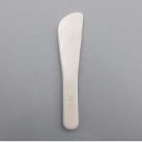 The white plastic spatula is likely a beauty accessory from the brand Yunjac.