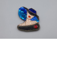 Brooch in the shape of a woman wearing a hat. Brooch in the shape of a woman wearing a hat.